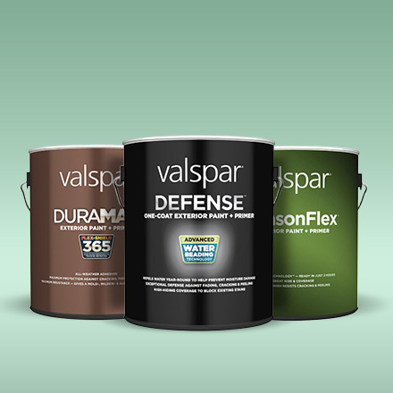 Trio of gallon cans of Duramax, Defense and SeasonFlex exterior paints against a soft green background.